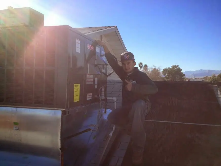 HVAC technician performing Boiler Repair on a rooftop unit in Wisconsin Rapids